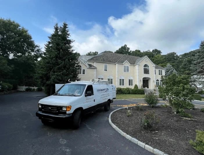 Painesville Power Washing technician performing thorough gutter cleaning service in Painesville