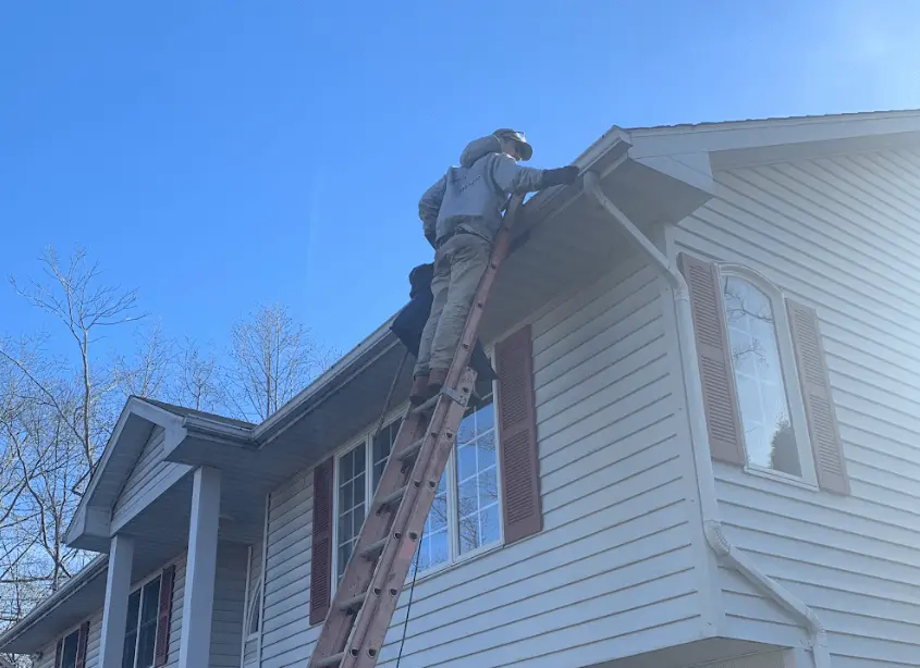 Gutter cleaning and maintenance being performed by Painesville Power Washing in Painesville